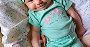 Cassie is registered to the contest to win money with this photo: apparel, baby, blanket, child, clothing, cozy, cute, elephant_design, fabric, happy, headband, indoors, infant, lying_down, mint_green, pacifier, person, smiling, soft_texture, young