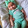 apparel, baby, blanket, child, clothing, cozy, cute, elephant_design, fabric, happy, headband, indoors, infant, lying_down, mint_green, pacifier, person, smiling, soft_texture, young