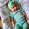 Cassie joined the competition — help win amazing prizes! baby, blanket, child, clothing, cute, fabric, face, hand, happy, headband, indoors, infant, lying_down, mint_green, pacifier, pattern, portrait, skin, smiling, toddler