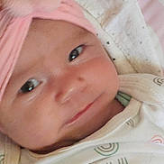 Cassie joined the competition — help win amazing prizes! baby, babywear, blanket, child, closeup, clothing, cozy, cute, face, flower, happy, headband, indoors, infant, newborn, person, portrait, sleepwear, smile, soft_lighting