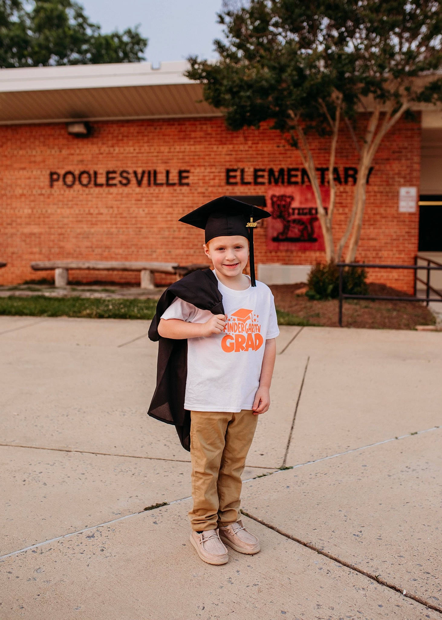 Cody is registered to the contest to win money with this photo: academic_dress, asphalt, event, fashion_accessory, formal_wear, fun, hat, headgear, headwear, joy, landscape, leisure, person, plant, road, sky, smile, street, temple, tourism