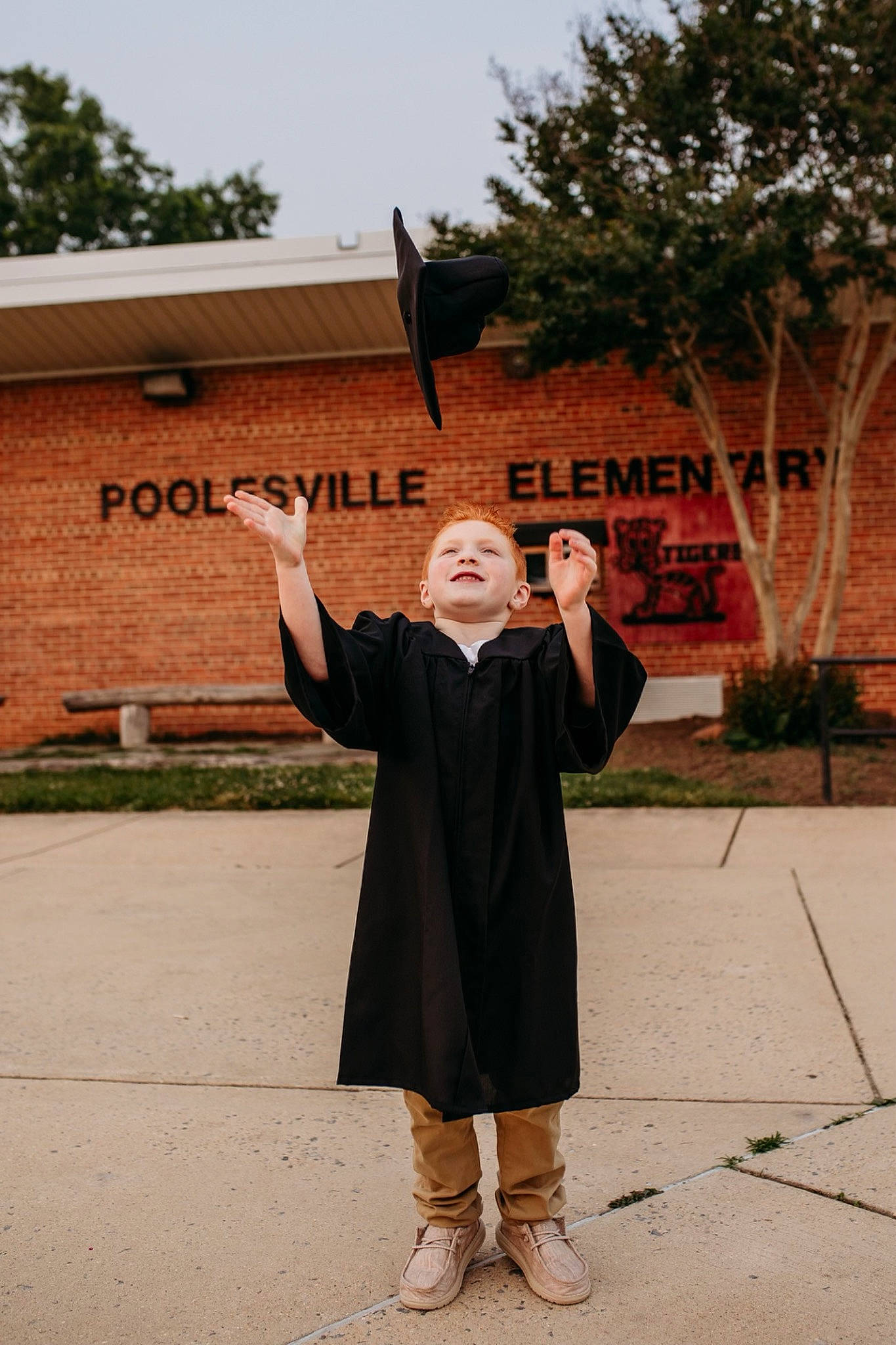 Cody joined the competition — help win amazing prizes! academic_dress, event, formal_wear, gesture, graduation, hand, headgear, joy, leisure, mortarboard, person, plant, sign_language, sky, smile, temple, thumb, tourism, travel, tree
