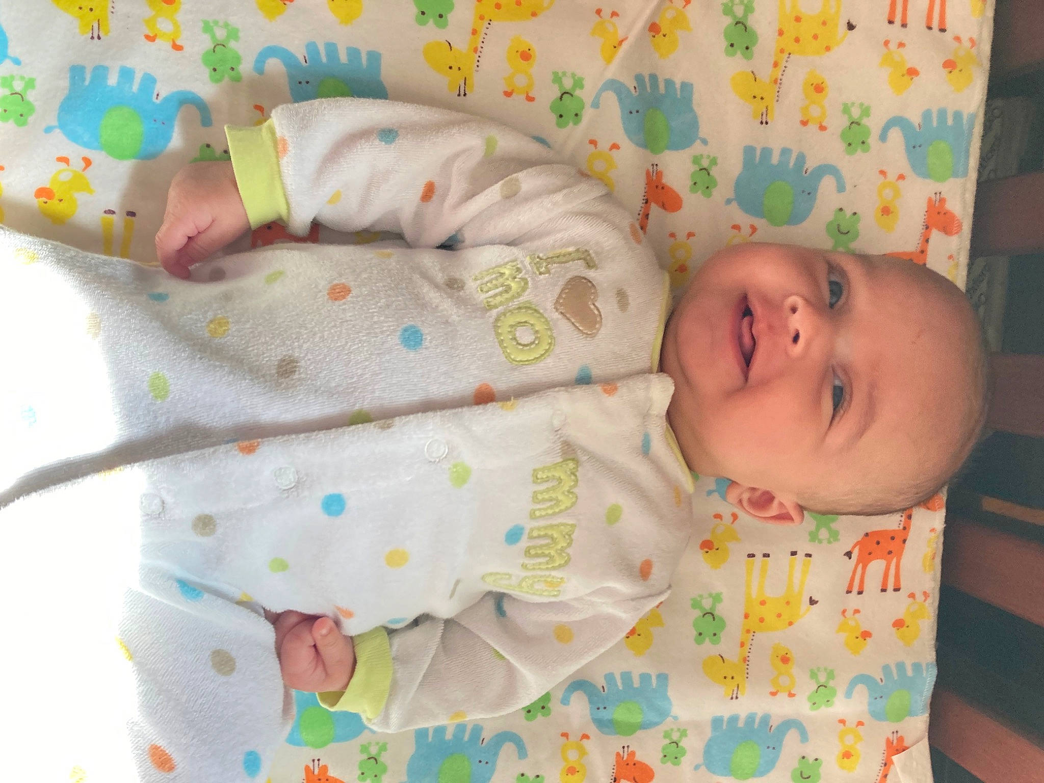 Tyler is registered to the contest to win money with this photo: baby, baby_products, baby_toddler_clothing, cheek, child, clothing, comfort, eye, facial_expression, green, head, human_body, linens, pattern, person, product, skin, sleeve, smile, toddler