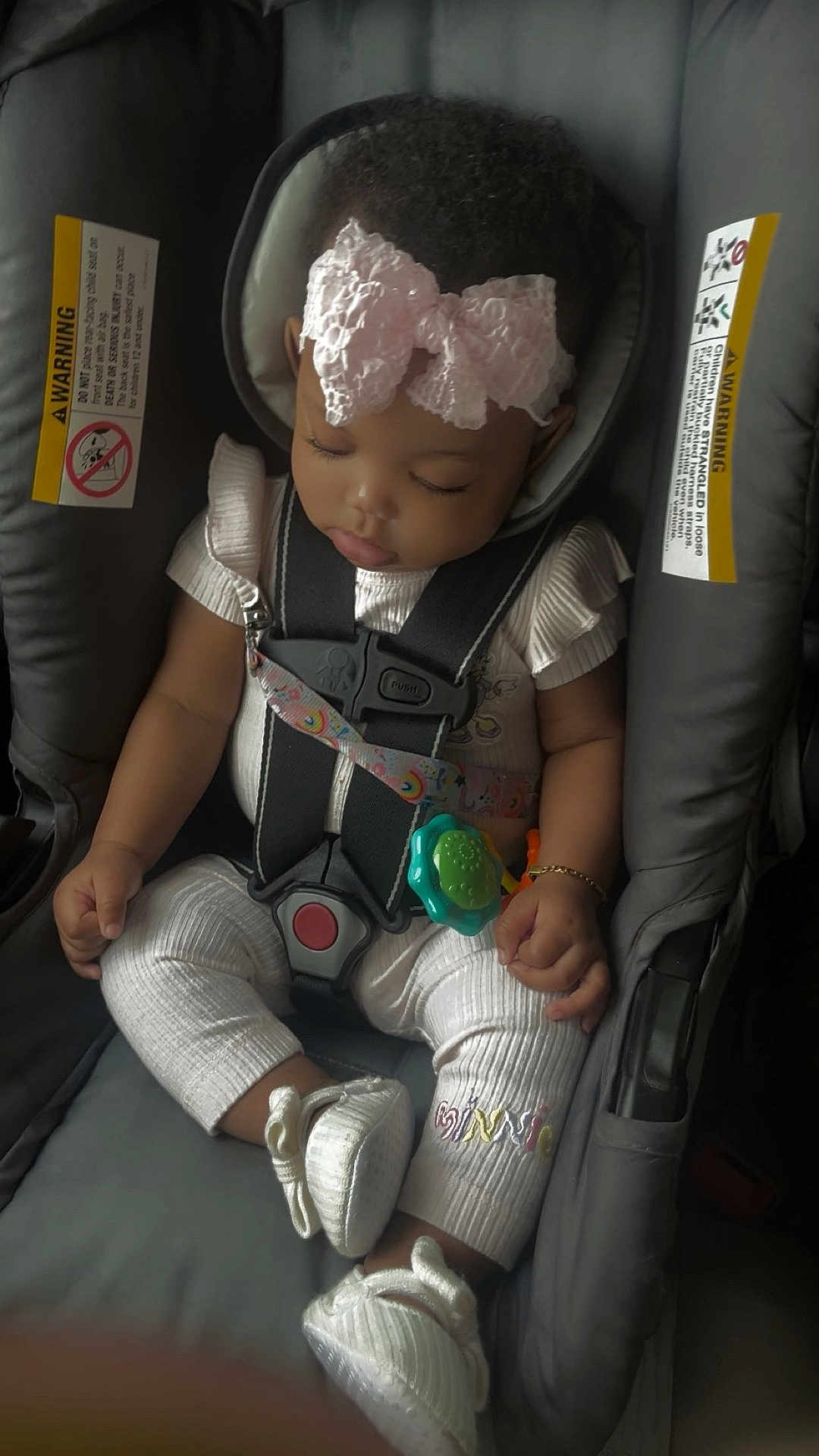 Amira joined the competition — help win amazing prizes! baby, sleeping, car_seat, bow, pink, infant, child, cute, straps, clothing, footwear, bracelet, toy, seatbelt, safety, peaceful, indoors, portrait, closeup, adorable