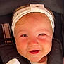 Rym a rejoint le concours — aidez-le/la à gagner de superbes lots ! baby, child, headband, smile, bottle, sparkling_water, stroller, face, happy, closeup, person, infant, cute, holding, seated, outdoor, sunlight, cheeks, clothing, portrait