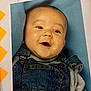 baby, smiling, denim_overalls, gray_shirt, chubby_cheeks, face, head, happy, infant, portrait, blue_background, cute, child, clothing, closeup, doodle, border, photo_frame, joyful, young