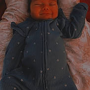 Maliah is registered to the contest to win money with this photo: baby, infant, sleeping, smiling, onesie, blue_clothing, blanket, butterfly_pattern, soft_fabric, cute, child, portrait, lying_down, peaceful, indoor, cozy, happy, newborn, resting, face