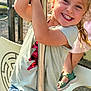 casual, child, fun, grip, hair, happy, joy, kid, legs, metal, outdoor, play, playground, pole, sandals, shorts, smiling, summer_clothing, sunlight, tshirt