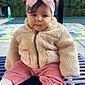 Amira is registered to the contest to win money with this photo: baby, child, toddler, portrait, sitting, outdoor, backyard, playground, pink_bow, headband, fleece_jacket, pink_pants, white_tights, baby_fashion, brown_hair, facial_expression, bench, poolside, greenery, brick_building
