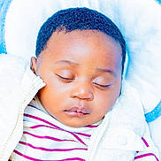 Ahmed joined the competition — help win amazing prizes! baby, sleeping, child, infant, cozy, striped_shirt, white_jacket, cushion, blue, soft, peaceful, closeup, face, portrait, relaxing, indoors, cute, young, resting, person