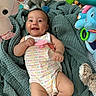 Gianna joined the competition — help win amazing prizes! baby, smile, blanket, plush_toy, green, infant, happy, clothing, onesie, cute, child, soft, toy, playpen, portrait, lying_down, indoors, face, person, infancy