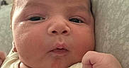 Leonardo is registered to the contest to win money with this photo: newborn, baby, infant, child, portrait, face, eyes, fist, hand, pajamas, teddy_bears, plush_toy, bed, blanket, indoors, cozy, lying_down, close_up, cute, photography
