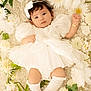 Emma joined the competition — help win amazing prizes! baby, infant, child, white_dress, bow, headband, flowers, floral_arrangement, blanket, soft_texture, socks, puffy_sleeves, cute, portrait, lying_down, adorable, innocent, skin, hand, footwear