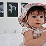 baby, child, floral_hat, floral_dress, indoor, portrait, cute, curious, person, face, skin, hand, earring, artwork, white_background, soft_lighting, infant, closeup, holding, expression