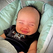 Ace joined the competition — help win amazing prizes! baby, infant, smile, closed_eyes, mohawk_hair, black_shirt, text_on_clothing, baby_seat, mint_green, blanket, cozy, cute, happy, portrait, child, newborn, hand, soft, indoor, resting