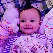 Ember is registered to the contest to win money with this photo: baby, smiling, blanket, plush_toy, pacifier, striped_clothing, face, child, infant, cozy, soft_toys, purple_lighting, lying_down, cute, happy, indoors, portrait, warm, comfort, head