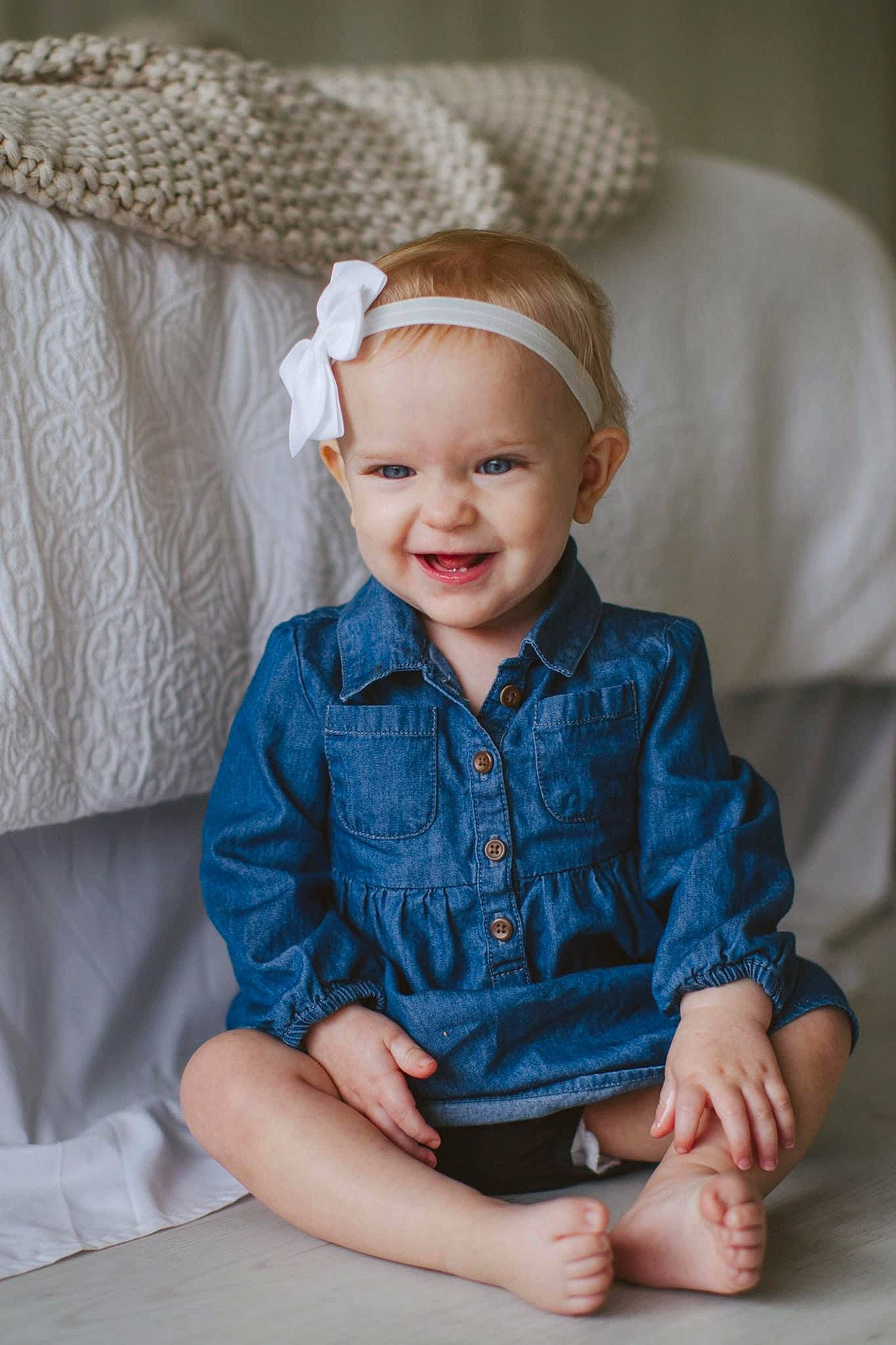 Emme is registered to the contest to win money with this photo: arm, baby_toddler_clothing, blond, dress, electric_blue, eye, flash_photography, hand, happy, hat, head, headgear, headpiece, headwear, iris, jewellery, joy, person, skin, sleeve