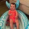 baby, child, colorful, couch, cute, floor, fun, happy, indoor, infant, inflatable_pool, person, play, relax, smile, summer, swimsuit, toy, water_play, young