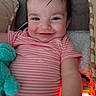 Isabel joined the competition — help win amazing prizes! baby, child, smiling, plush_toy, pink_clothing, striped_shirt, face, arm, toy, indoor, happy, cute, infant, lying_down, person, soft_toy, warm_light, young_child, portrait, cuddling
