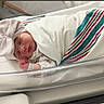 newborn, baby, sleeping, hospital, bassinet, blanket, bow, hat, swaddled, infant, child, cute, resting, face, bed, healthcare, person, soft, cozy, small