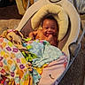 Jabari joined the competition — help win amazing prizes! baby, infant, smile, blanket, baby_swing, cushion, happy, child, indoors, carpet, colorful, cozy, cute, person, furniture, home, comfort, soft, wrapped, resting
