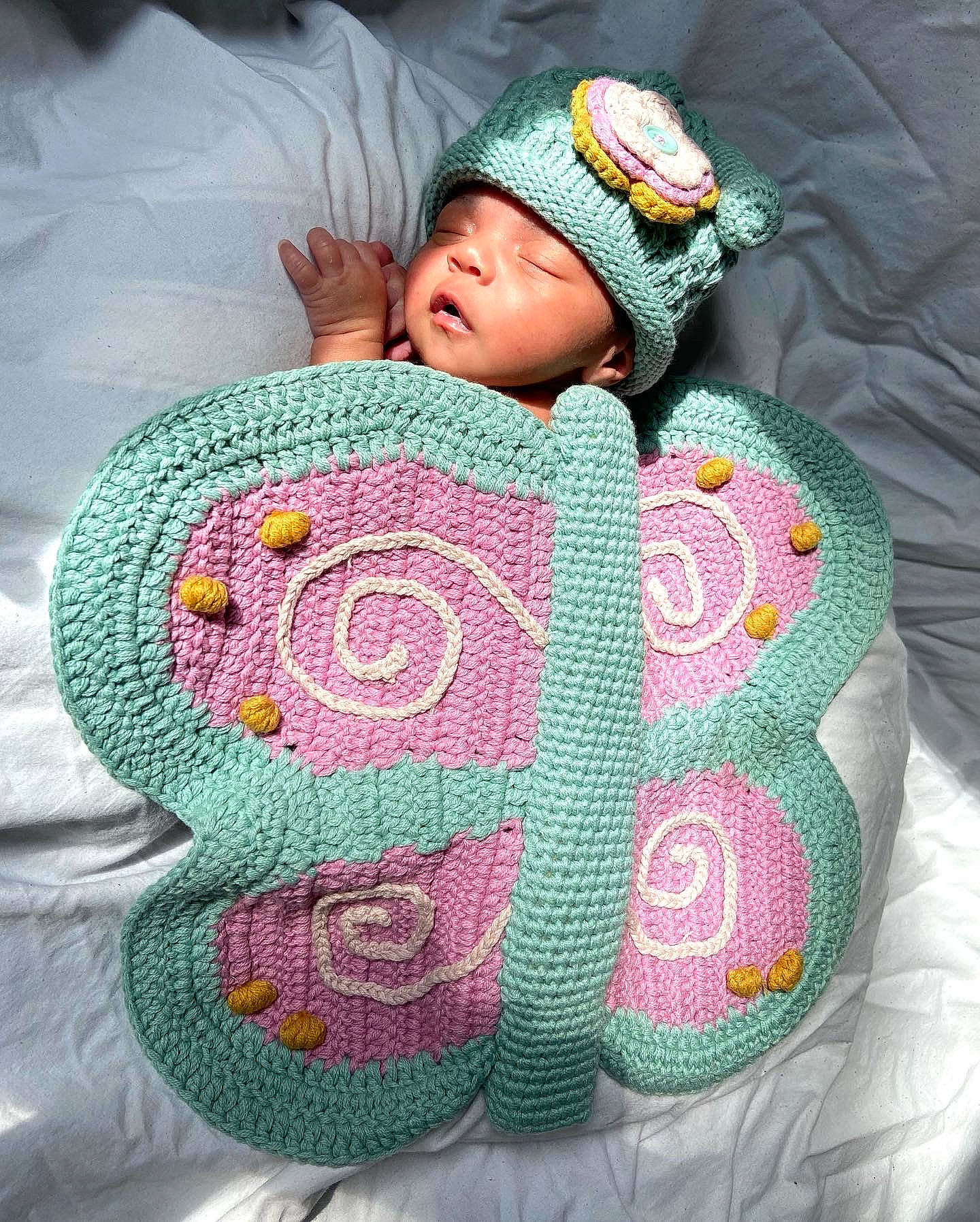Nevaeh joined the competition — help win amazing prizes! art, baby, baby_sleeping, baby_toddler_clothing, cap, comfort, eye, face, green, headgear, headwear, knit_cap, linens, magenta, pattern, person, pink, product, sleeve, textile