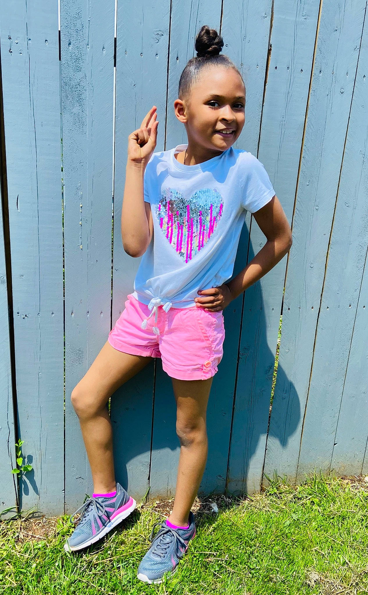 Aakylah is registered to the contest to win money with this photo: child, electric_blue, face, grass, happy, head, joy, magenta, people_in_nature, person, pink, plant, shorts, smile, sneakers, standing, street_fashion, summer, t_shirt, thigh