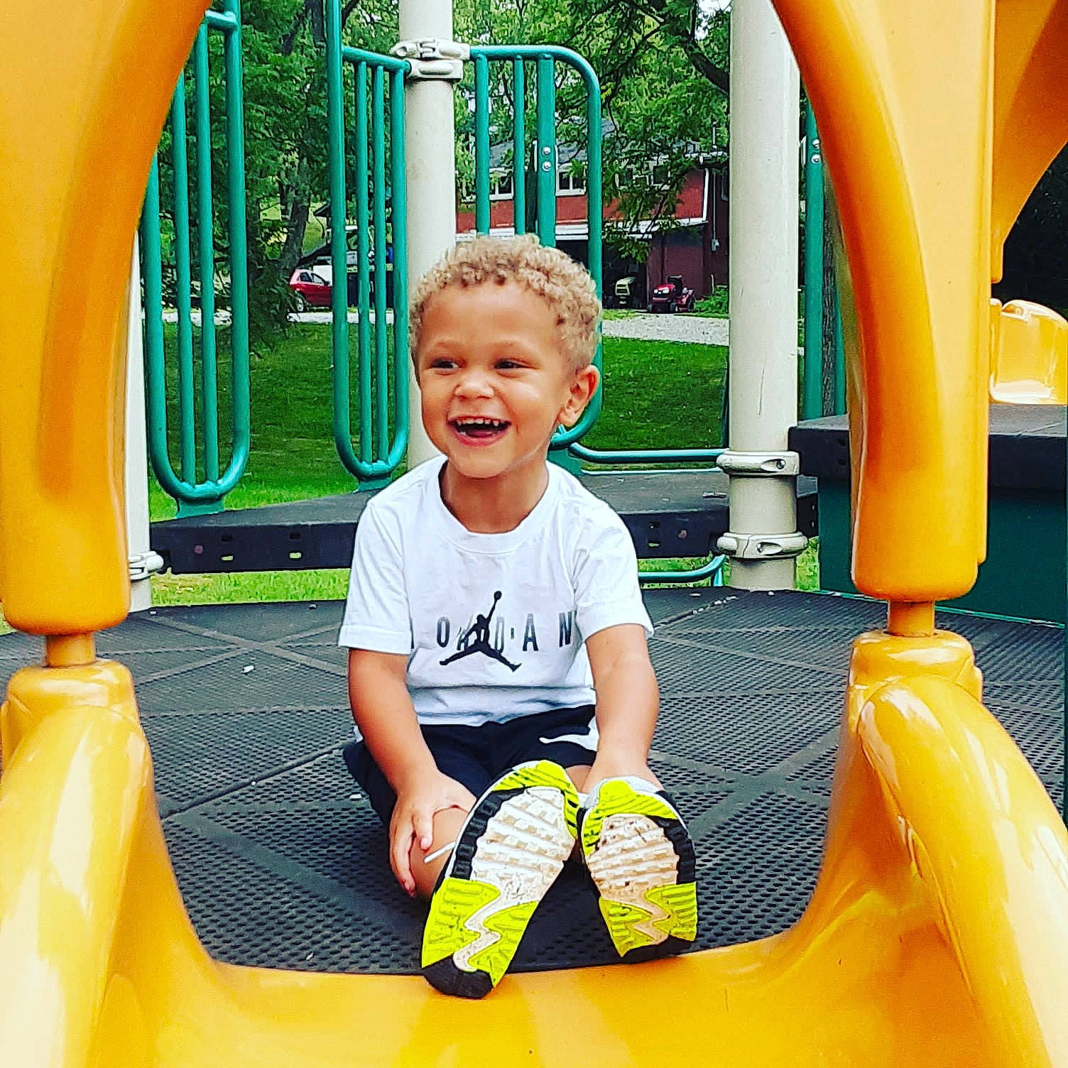 Cannon is registered to the contest to win money with this photo: child, chute, city, fun, games, human_settlement, joy, leisure, outdoor_play_equipment, person, play, playground, playground_slide, public_space, recreation, smile, summer, toddler, vacation, yellow