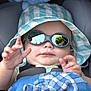 Néoh a rejoint le concours — aidez-le/la à gagner de superbes lots ! baby, child, sunglasses, hat, car_seat, reflection, hand, face, clothing, blanket, blue, striped, outdoor, sunny, infant, seatbelt, cute, person, portrait, young