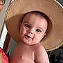 baby, child, hat, straw_hat, smile, cheeks, face, person, indoor, adult_partial, glasses, skin, headwear, closeup, cute, portrait, happy, young_child, human, fashion