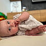 éléonore a rejoint le concours — aidez-le/la à gagner de superbes lots ! baby, infant, child, blue_eyes, sucking_fingers, lying_down, soft_focus, indoors, toy, couch, blanket, furniture, curious, cute, portrait, skin, clothing, hand, face, home