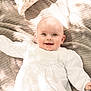 éléonore participe au concours pour gagner de l'argent avec cette photo : baby, infant, smile, white_clothing, blanket, soft_texture, lying_down, happy, portrait, child, cute, indoors, natural_light, face, small_hand, head, cheerful, young_child, fabric, cozy