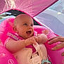 baby, blue_eyes, canopy, child, closeup, cute, float, hand, happy, infant, inflatable, outdoor, pink, playful, pool, safety_vest, smiling, summer, sunlight, water