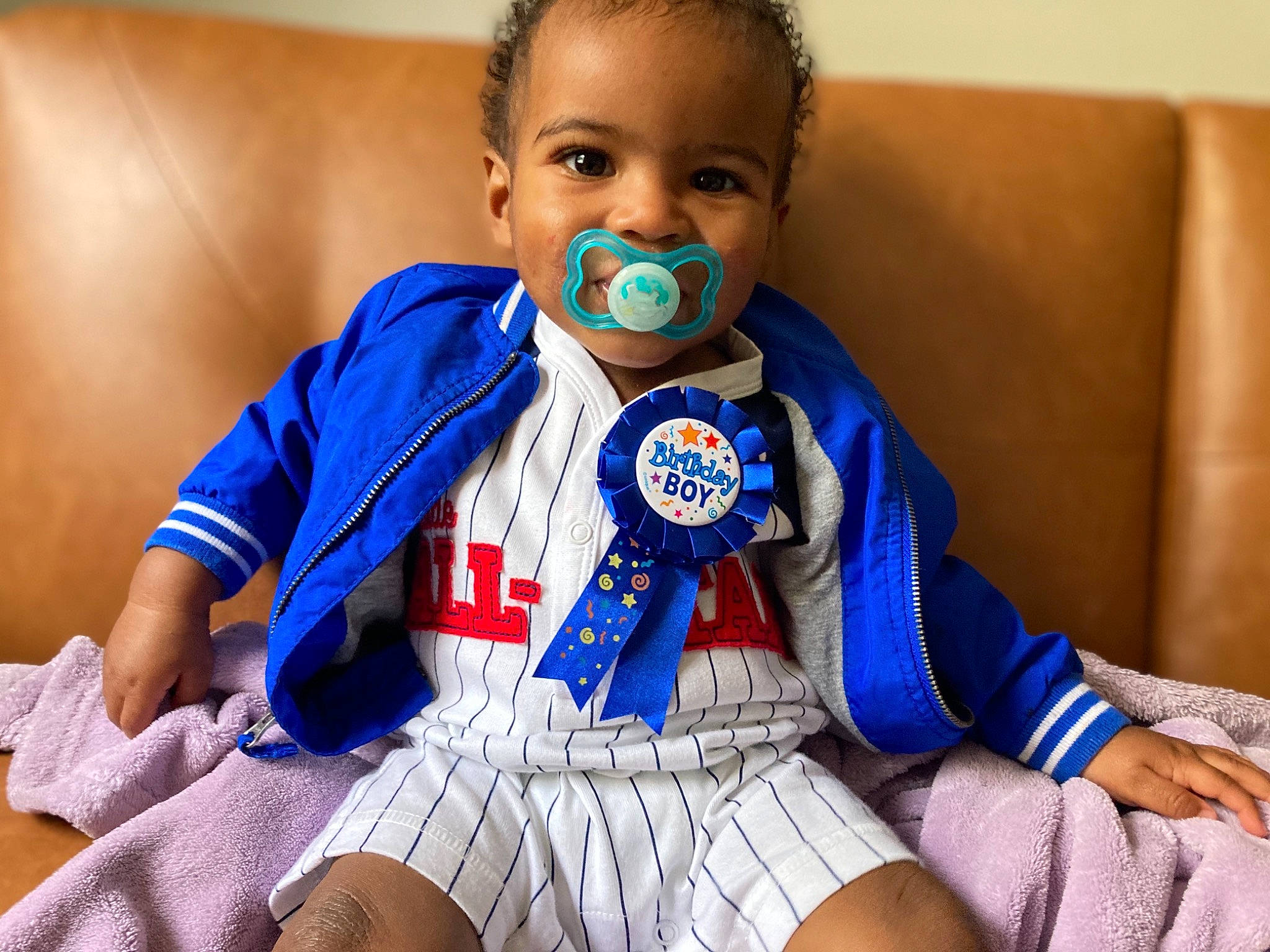 Andrue is registered to the contest to win money with this photo: abdomen, baby, baby_toddler_clothing, child, comfort, elbow, electric_blue, eye, happy, human_body, jersey, neck, person, personal_protective_equipment, skin, sleeve, smile, sportswear, t_shirt, toddler