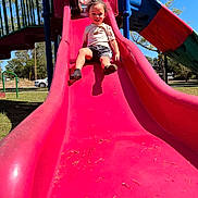 Kyzer is registered to the contest to win money with this photo: child, toddler, slide, playground, outdoor, fun, park, sunny, grass, happy, smiling, clothing, play, recreation, person, summer, activity, youth, leisure, family