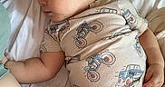 Leon joined the competition — help win amazing prizes! baby, bed, blanket, car_print, child, cute, floral_pattern, hand, head, indoors, infant, motorcycle_print, onesie, peaceful, person, pillow, resting, skin, sleeping, soft_lighting