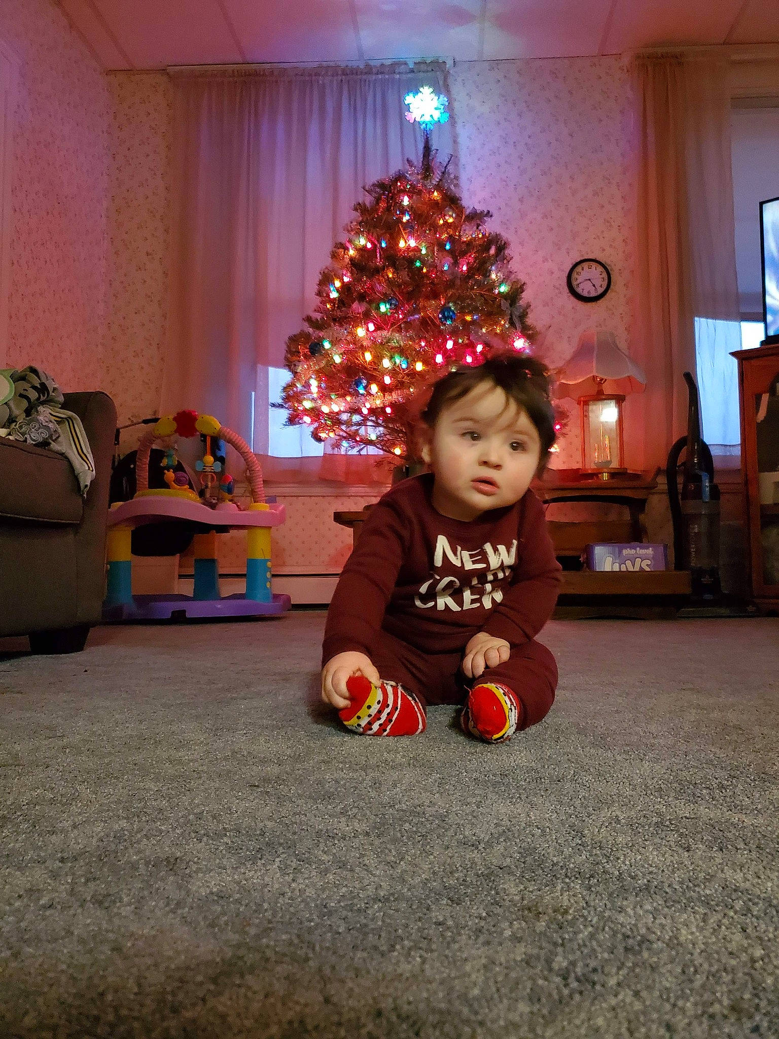 Karson joined the competition — help win amazing prizes! baby_toddler_clothing, carmine, child, christmas, christmas_decoration, christmas_eve, christmas_ornament, christmas_tree, floor, flooring, holiday, holiday_ornament, home, interior_design, lighting, living_room, ornament, person, room, toddler