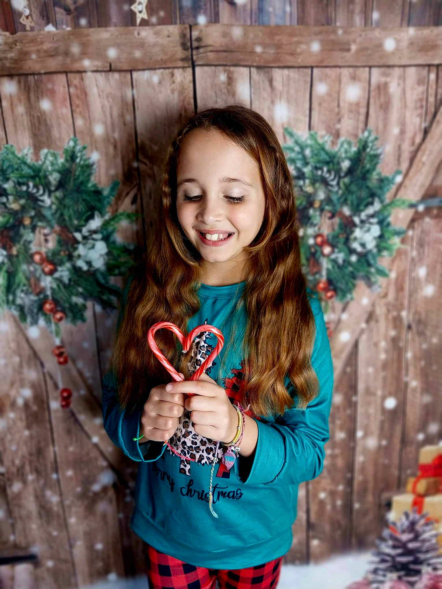 Makenzie joined the competition — help win amazing prizes! child, christmas, christmas_decoration, christmas_ornament, clothing, electric_blue, event, facial_expression, fun, hair, happy, holiday, joy, long_hair, person, plant, sleeve, smile, standing, t_shirt