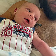 Jason joined the competition — help win amazing prizes! baby, infant, adult, beard, tattoo, blanket, pillow, shirtless, lying_down, closeup, indoors, bonding, family, comfort, cute, child, person, casual, portrait, toddler