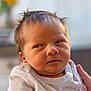 Luca is registered to the contest to win money with this photo: baby, newborn, infant, person, face, expression, clothing, hand, skin, hair, portrait, closeup, cute, indoor, soft_light, holding, sleeve, newborn_baby, young_child, human