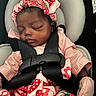 baby, infant, sleeping, car_seat, harness, strawberry, bow, headband, pink_outfit, dress, blanket, portrait, face, closed_eyes, peaceful, indoors, vehicle, safe, cushion, photography