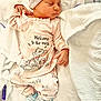 Paisley is registered to the contest to win money with this photo: newborn, baby, sleeping, pajamas, hat, blanket, bed, infant, clothing, cute, soft, striped_socks, cozy, resting, peaceful, child, portrait, indoors, sleep, small
