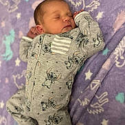 Paisley joined the competition — help win amazing prizes! newborn, baby, sleeping, onesie, cartoon_print, grey_clothing, purple_blanket, stars, unicorns, soft_texture, infant, cute, peaceful, child, portrait, indoors, resting, adorable, sleep, cozy