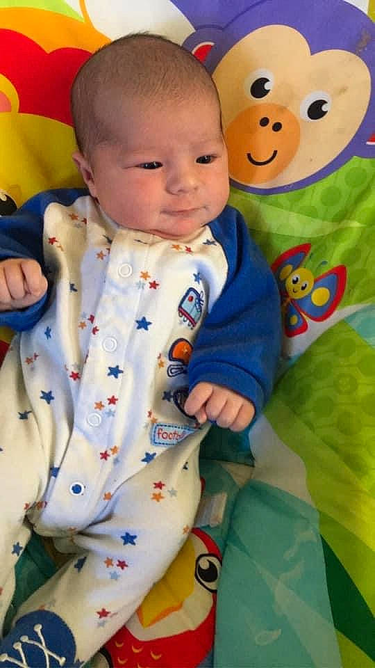 Chase is registered to the contest to win money with this photo: baby, baby_toddler_clothing, blazer, cheek, child, collar, face, facial_expression, hairstyle, happy, head, nose, orange, organ, person, product, skin, sleeve, textile, toddler