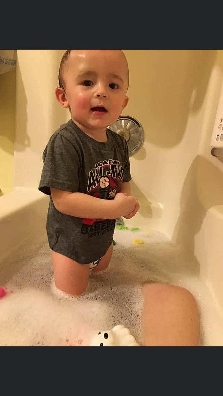 Logan joined the competition — help win amazing prizes! arm, baby, baby_toddler_clothing, bathing, bathroom, bathtub, cheek, finger, fun, joint, mouth, person, plumbing, plumbing_fixture, shorts, shoulder, skin, sleeve, t_shirt, toddler