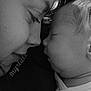 baby, adult, close_up, black_and_white, sleeping, face, portrait, intimacy, love, mother_and_child, peaceful, expression, skin, hair, profile, tenderness, rest, affection, cuddle, monochrome