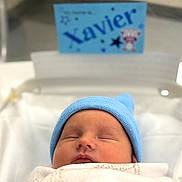 Xavier joined the competition — help win amazing prizes! newborn, baby, sleeping, blue_hat, blanket, hospital, bassinet, infant, cute, cozy, portrait, child, peaceful, resting, indoors, soft_light, name_card, closeup, wrapped, sleep
