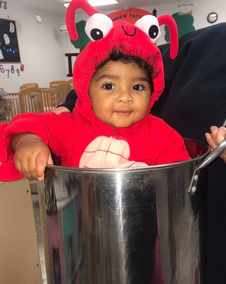 Maylani is registered to the contest to win money with this photo: baby, baby_products, baby_toddler_clothing, chair, cheek, child, costume, event, fun, fur, happy, headwear, icing, organ, person, personal_protective_equipment, product, red, sleeve, smile