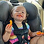 Realynn is registered to the contest to win money with this photo: toddler, child, car_seat, snack, cheese_puffs, smiling, happy, colorful_clothing, seatbelt, car_interior, face, hand, hair, mouth, orange_snack, eating, cute, young_child, sitting, daylight