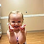 baby, beige_wall, bright, cartoon_clothing, casual, child, cute, expression, fun, happy, indoor, person, playful, pointing, portrait, short_hair, smiling, toddler, wooden_floor, young_child